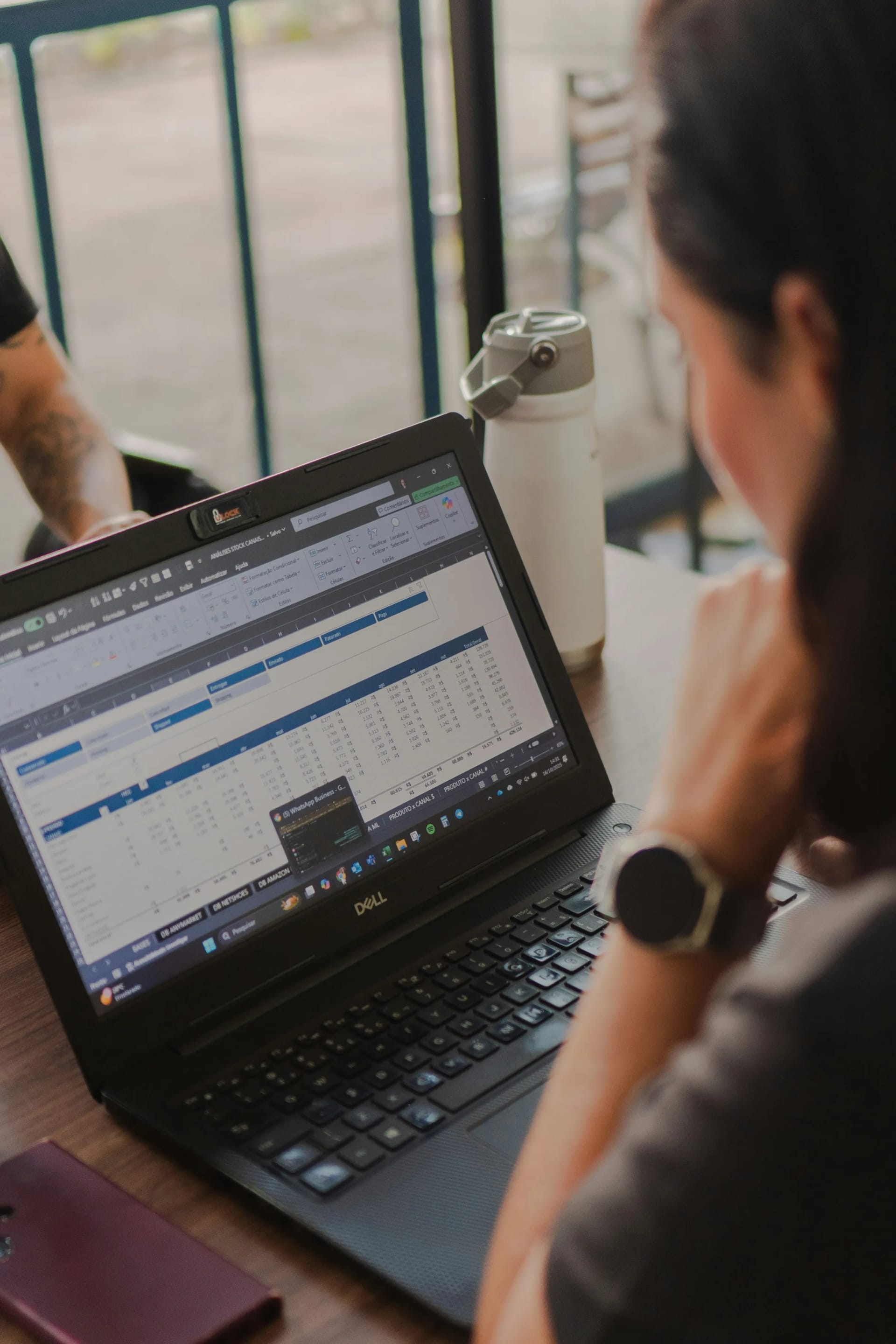 Person working with an Excel spreadsheet on a laptop at a desk